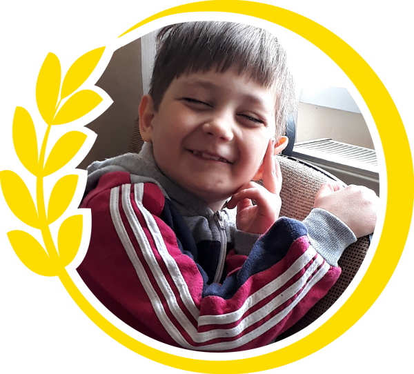 Round photo of a little boy surrounded by yellow circle of wheat