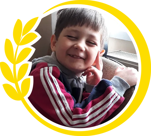 Round photo of a little boy surrounded by yellow circle of wheat